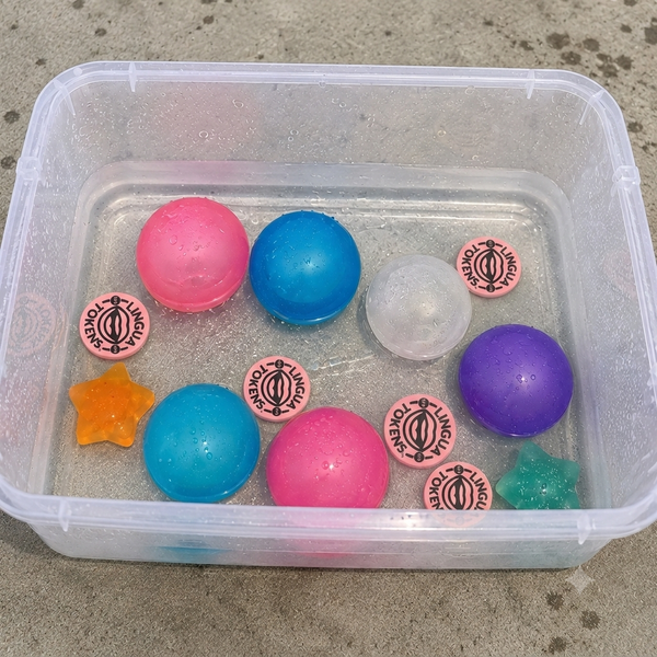 Lingua Tokens sink in water with reusable water balloons used in a creative speech therapy activity 
